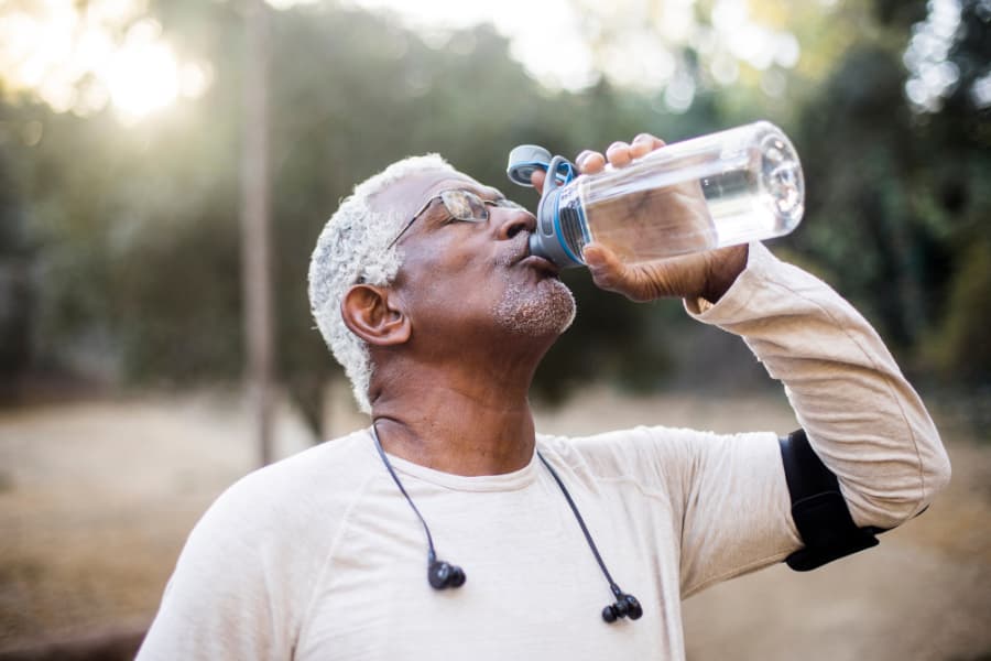 Man with bph drinking water